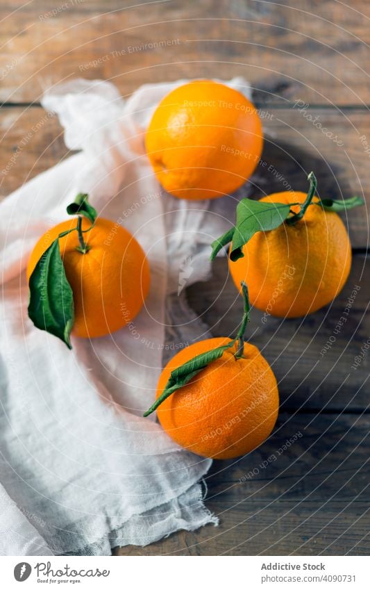 Fresh oranges on table fresh napkin food natural organic fruit juice ingredient vegan vegetarian sweet tasty yummy delicious cloth fabric wooden lumber timber