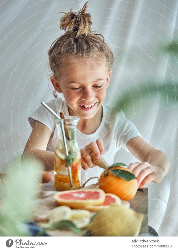 Boy pressing grapefruit for juice boy reamer drink health food healthy people lemonade lifestyle fresh person organic nutrition juicing diet kitchen beverage