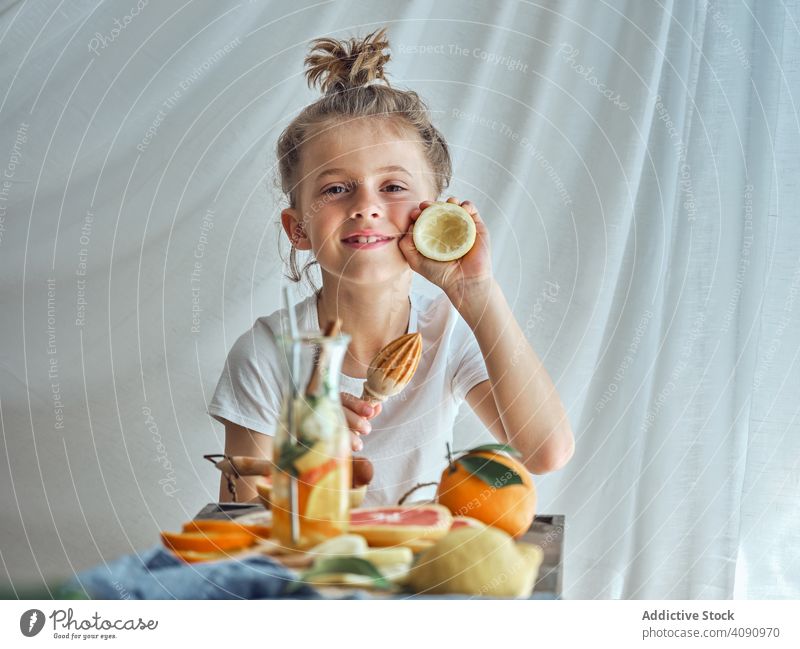 Boy holding reamer and peel of lemon boy pressing juice orange drink health food healthy people lifestyle fresh fruit person organic nutrition juicing kitchen