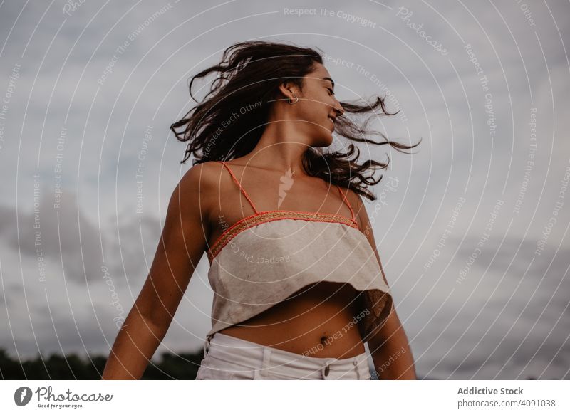 Cheerful woman dancing near lake smiling closed eyes hands up excited young nature water female calm tranquil cheerful happy joy activity raised lady lifestyle