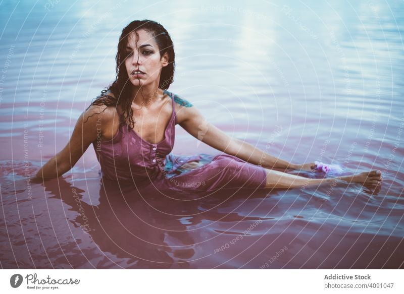 Woman in wet dress sitting in water woman young beautiful sea female relax lifestyle summer concept posing model ocean attractive people alone relaxation coast