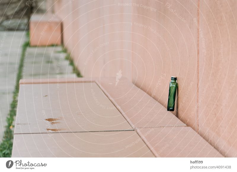 an empty green hip flask on a pink bench Flachman Alcoholic drinks Alcoholism bottle of booze drunk up Empty Spirits Bottle Glass Drinking Beverage Addiction