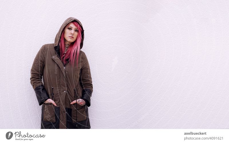 young woman with pink hair, piercings and tattoos Young woman Piercing Tattoo E-Girl Hipster real people Subculture pierced Tattooed Alternative Parka Emo