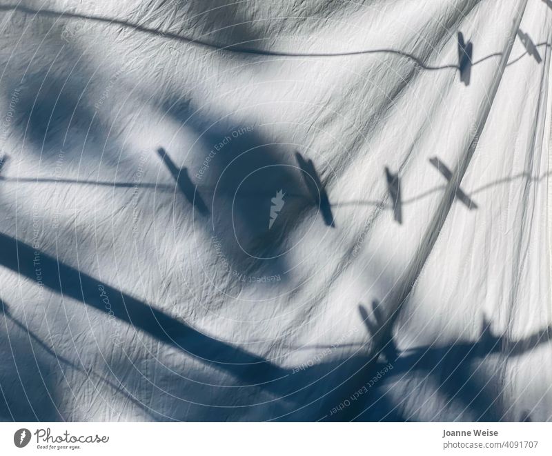 White sheet on clothesline with peg shadows. Shadow pegs Clothesline sunny day white sheet Laundry Washing Washing day Dry Housekeeping Fresh Hang Clean Summer