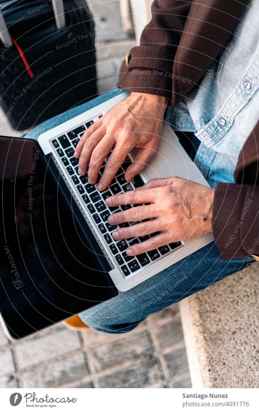 Close up of an unrecognizable business man using laptop. close up type 50s hands person lifestyle people middle aged handsome senior outdoors caucasian city