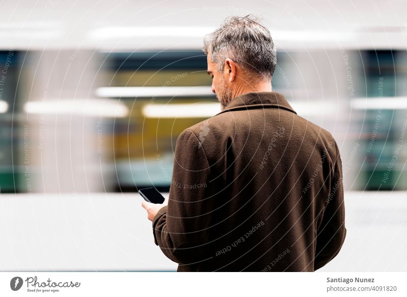 Unrecognizable business man using smartphone in the underground. person lifestyle people middle aged handsome senior caucasian city adult male portrait casual