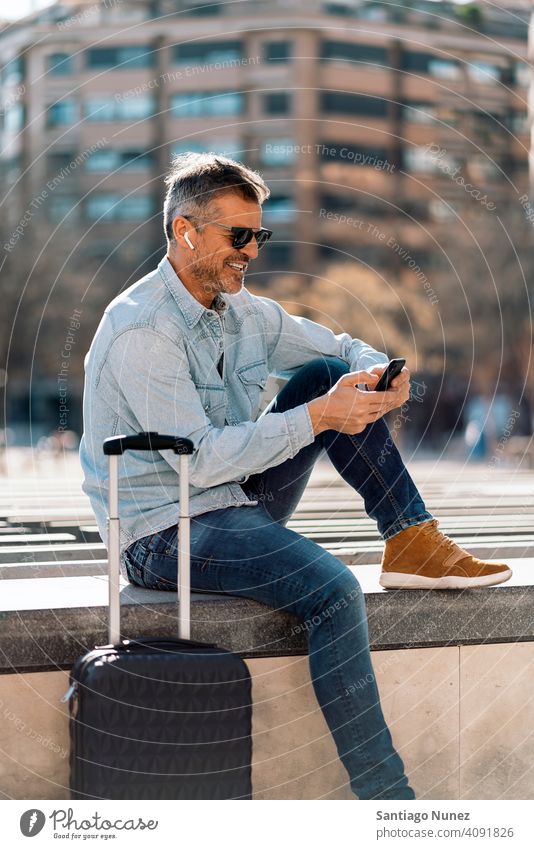 Business man listening to music in the street. person lifestyle people middle aged handsome senior outdoors caucasian city adult male portrait casual urban