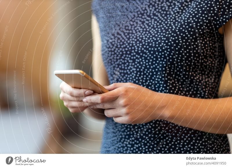 Young businesswoman using mobile phone in her office girl people Entrepreneur successful professional young adult female lifestyle indoors millennial attractive