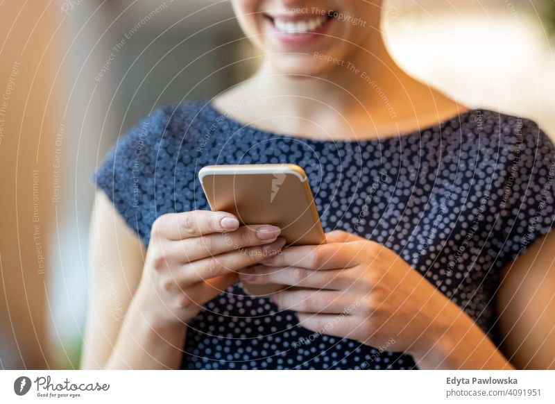 Young businesswoman using mobile phone in her office girl people Entrepreneur successful professional young adult female lifestyle indoors millennial attractive