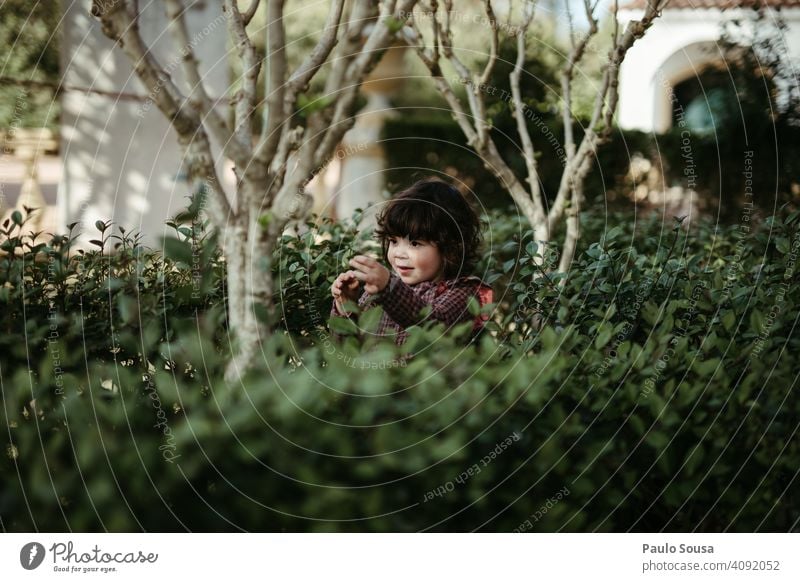 Child playing in the park childhood Authentic Girl 1 - 3 years Caucasian Lifestyle Day Joy Childhood memory Infancy Colour photo Human being Bushes Green Spring