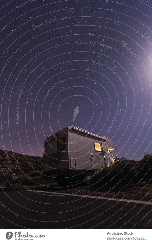 Caravan on roadside under night starry sky caravan travel desert camper road trip tenerife spain light parking stunning vacation tourism tourist evening trailer