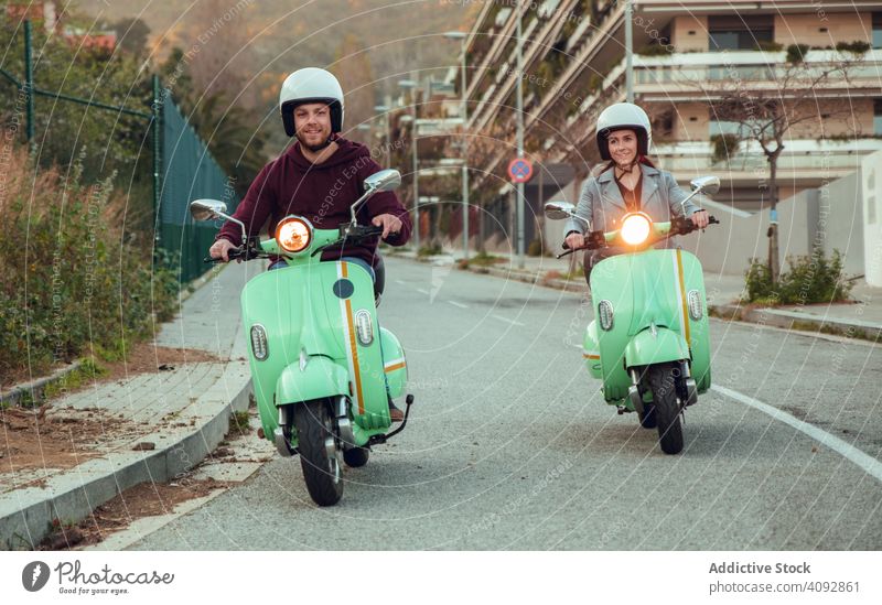 Young people riding motorcycles on city road helmet friendship scooter bike activity leisure street adventure travel enjoying transportation motorbike young