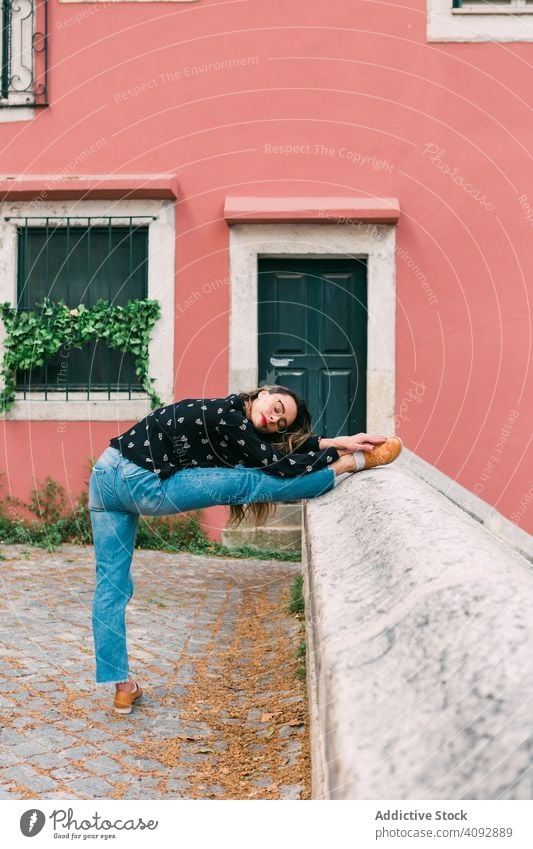 Casual woman dancing on old city street dance stretch grace young teen gymnastic stairway action active exercise sensual contemporary flexible pretty posture