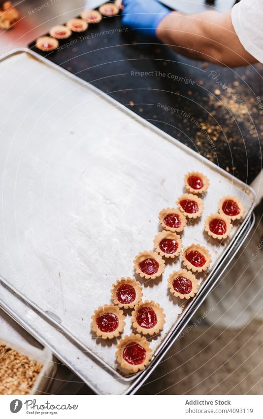 Tray with pig shaped desserts in bakery pastry rack tray symbol small pink cake ear snout food sweet fresh small business event preparation decor patisserie