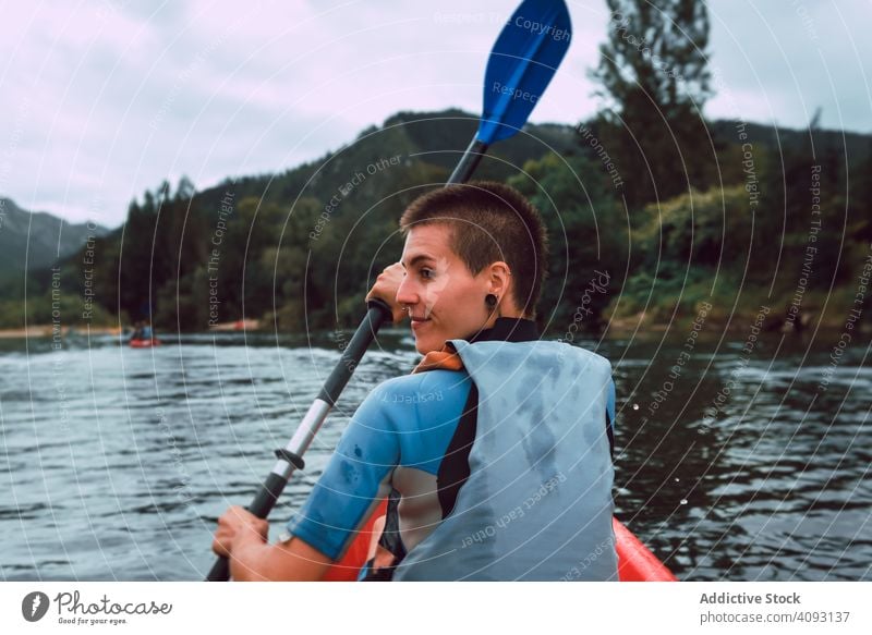 Female kayaking with paddle in raised hands woman sport sella river spain water canoe activity tourism adventure lifestyle travel female joyful athletic fit