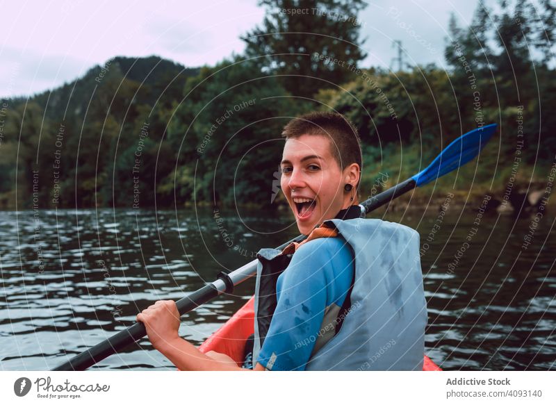 Female kayaking with paddle in raised hands woman sport sella river spain water canoe activity tourism adventure lifestyle travel female joyful athletic fit