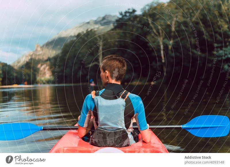 Female kayaking with paddle in raised hands woman sport sella river spain water canoe activity tourism adventure lifestyle travel female joyful athletic fit