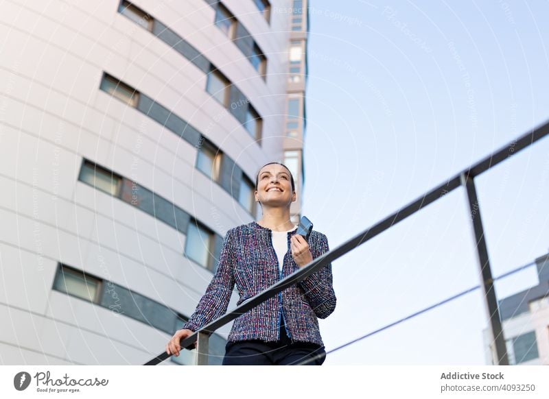 Serious businesswoman leaning on railing building street office serious city elegant modern urban female concerned manager entrepreneur career exterior jacket