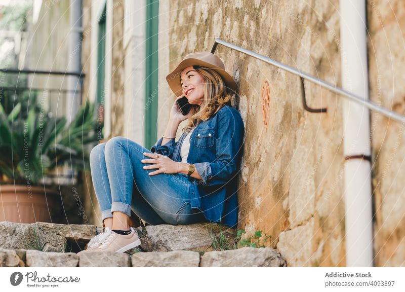 Woman with smartphone sitting on stone steps of stairs woman happy beautiful talking attractive charming relaxation street female confident model communication