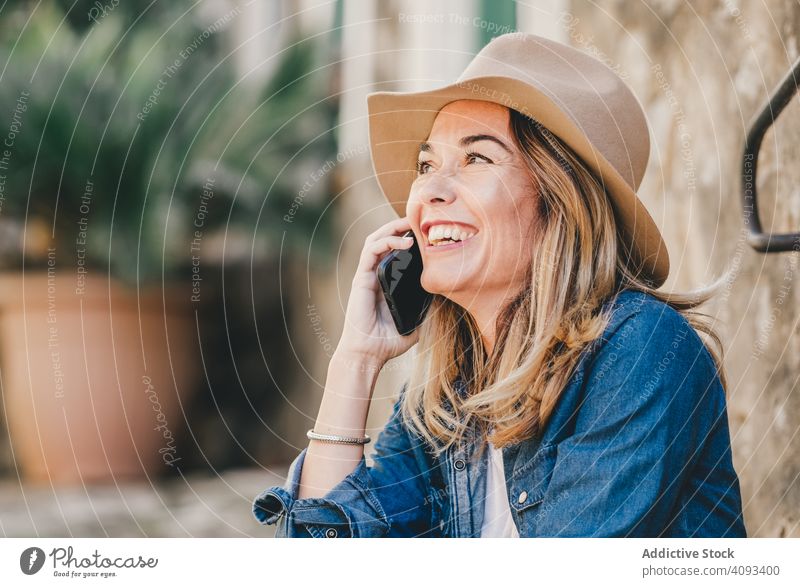 Woman with smartphone sitting on stone steps of stairs woman happy beautiful talking attractive charming relaxation street female confident model communication