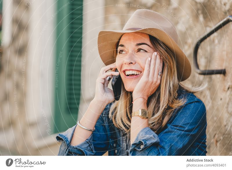 Woman with smartphone sitting on stone steps of stairs woman happy beautiful talking attractive charming relaxation street female confident model communication