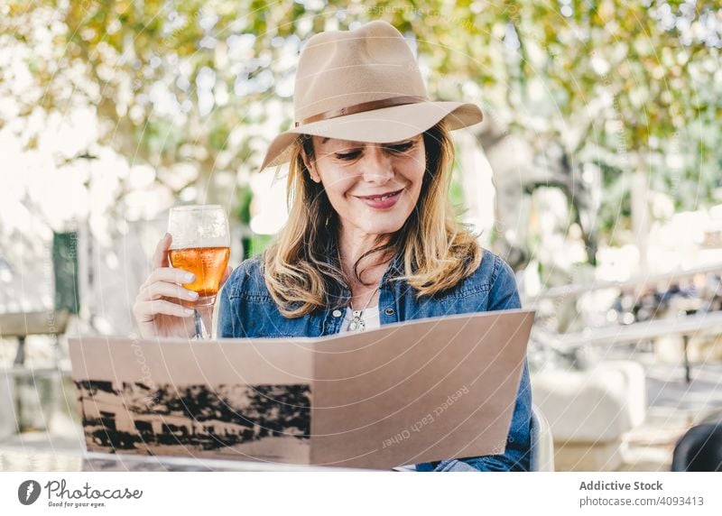 Woman sitting outside cafe drinking beer woman beautiful charming relaxation glass happy female alcohol street confident smile lovely beverage stylish fresh