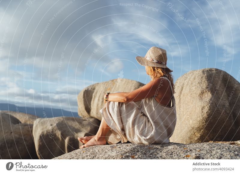 Carefree lady enjoying rest on coast near cliffs woman carefree travel optimistic seaside happy smile hat trip vacation gorgeous sunglasses recreation cheerful