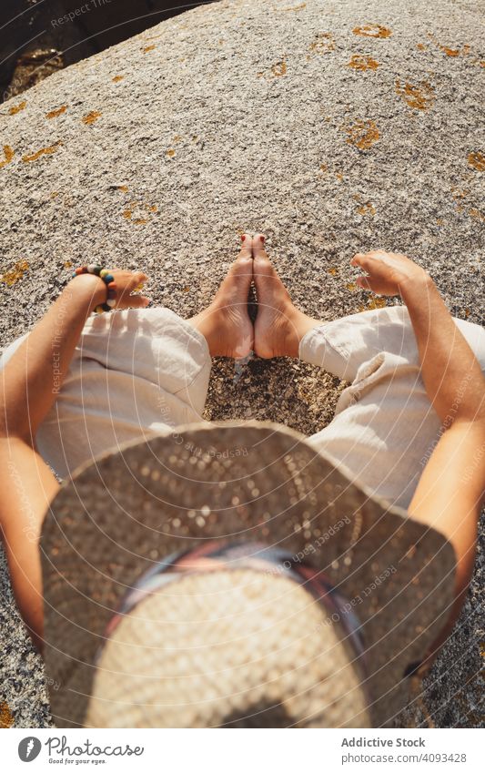 Person relaxing while sitting on stone meditation harmony shore sunlight zen warm practice moment bright peace power contemplate vacation peaceful freedom rock