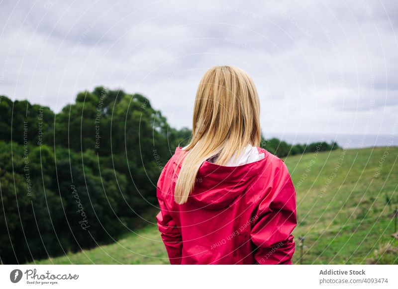 Woman standing in countryside and looking away peaceful woman field enjoying forest nature female green relaxation casual autumn season lady plant human natural