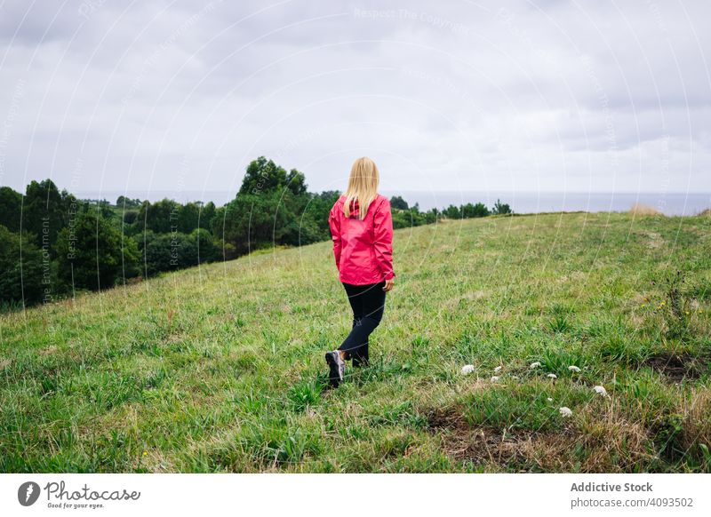 Woman standing in countryside and looking away peaceful woman field enjoying forest nature female green relaxation casual autumn season lady plant human natural