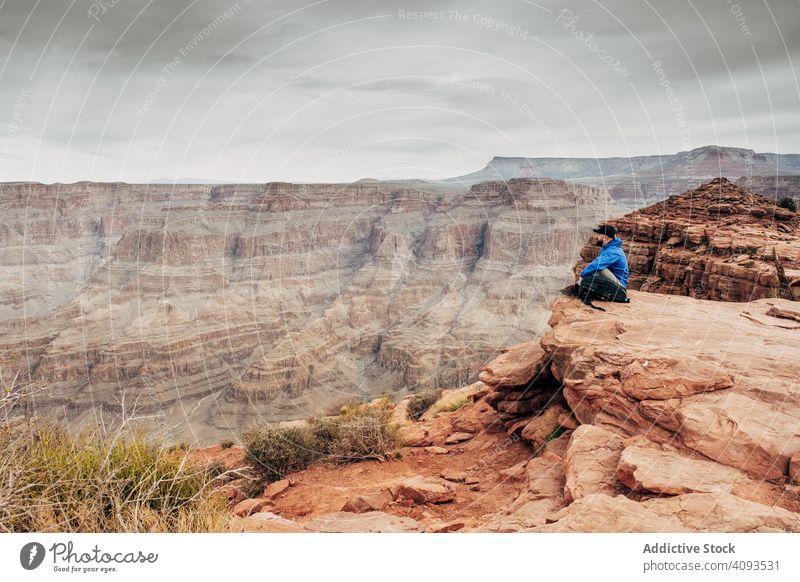 Man having break on top of rock man cliff canyon weary relax admire landscape male usa nature recreation hiking tourism adventure extreme sport wild travel