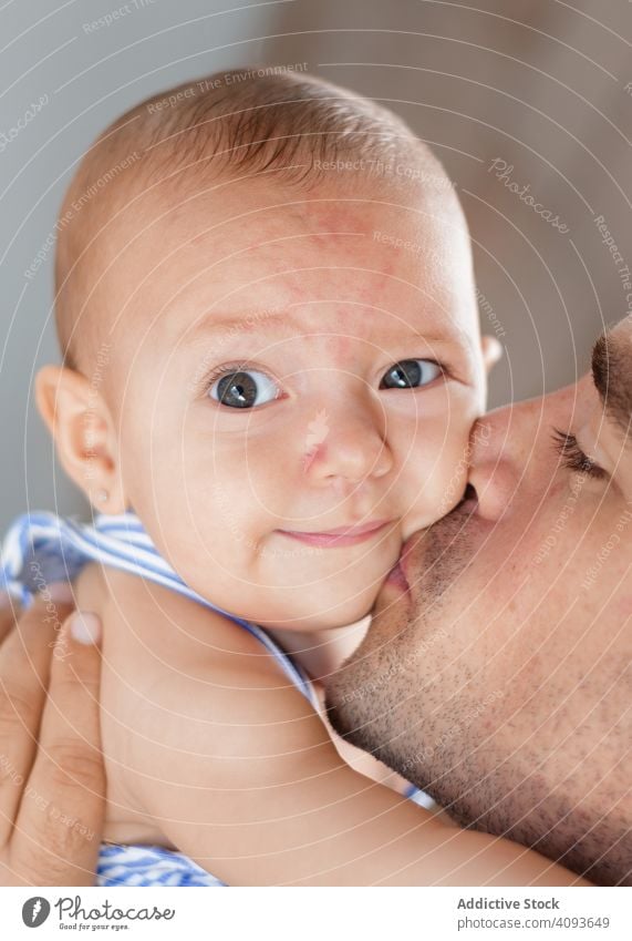 Father kissing baby on cheek father love family child adult man happy childhood kid parent toddler smile closed eyes joy affection closeness bonding fondness