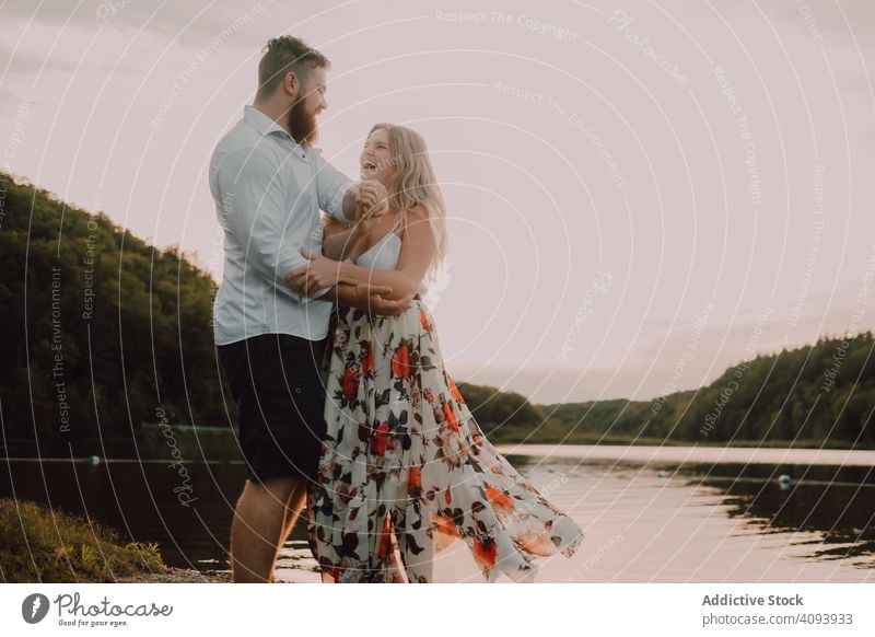 Loving couple standing ankle deep in water on beach hug love lake tender shore adorable embrace coast vacation nature honeymoon caress together affection