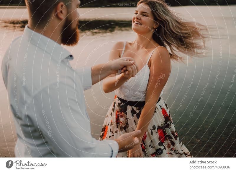 Loving couple standing ankle deep in water on beach hug love lake tender shore adorable embrace coast vacation nature honeymoon caress together affection