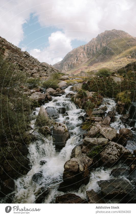 Picturesque waterfall in mountains rock landscape nature fairy pool travel tourism destination scenery stream flow bubble powerful stone valley picturesque