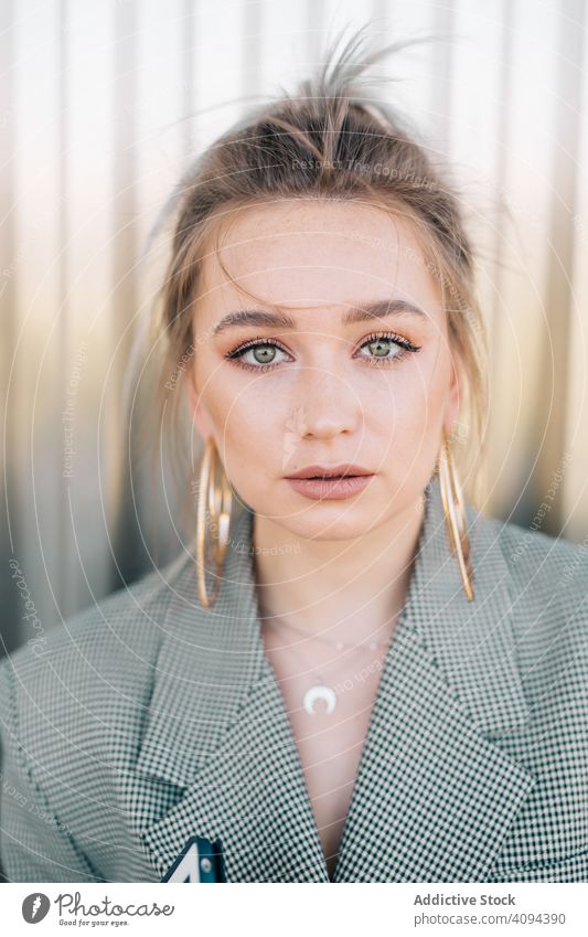 Woman with tablet in stylish suit standing nearby wall holding sunglasses businesswoman working using trendy communication manager career entrepreneur screen