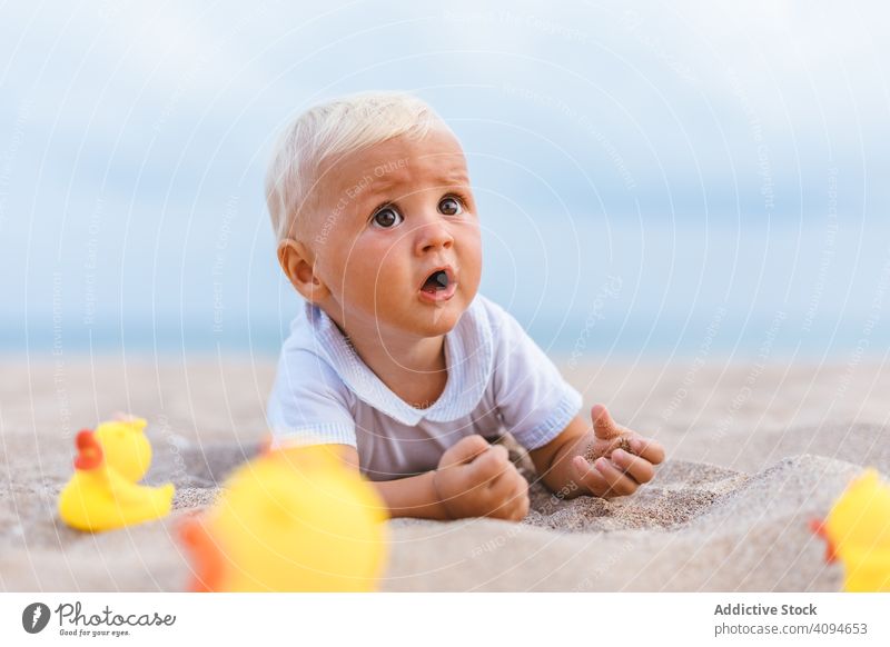 Baby boy playing with rubber ducks summer beach toys innocence happy little 5 months blond life little infancy childcare male newborn sweet caucasian infant