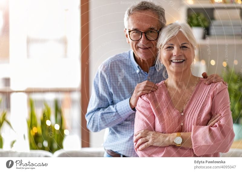 Happy senior couple at home people woman adult mature casual attractive female smiling happy Caucasian toothy enjoying two people love relationship portrait