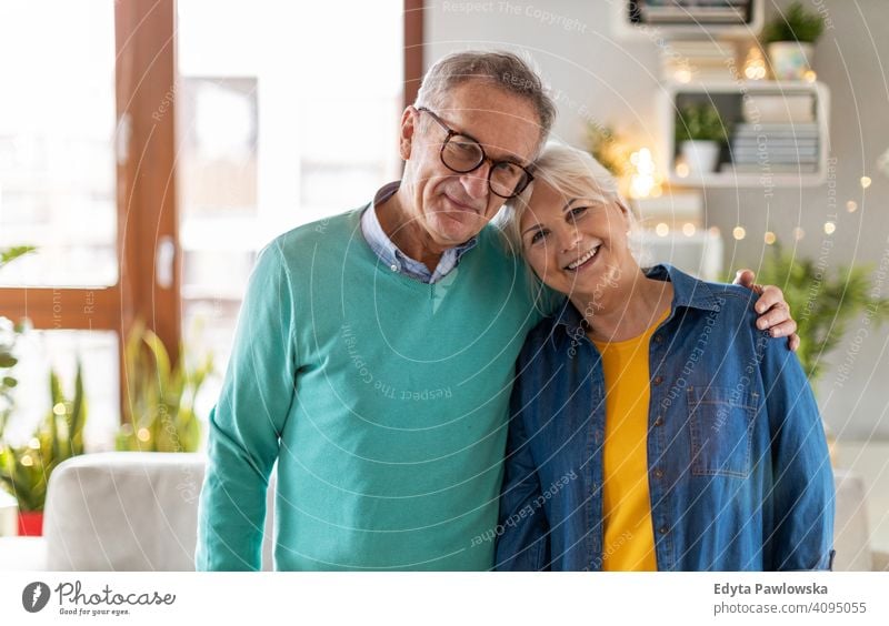 Happy senior couple at home people woman adult mature casual attractive female smiling happy Caucasian toothy enjoying two people love relationship portrait