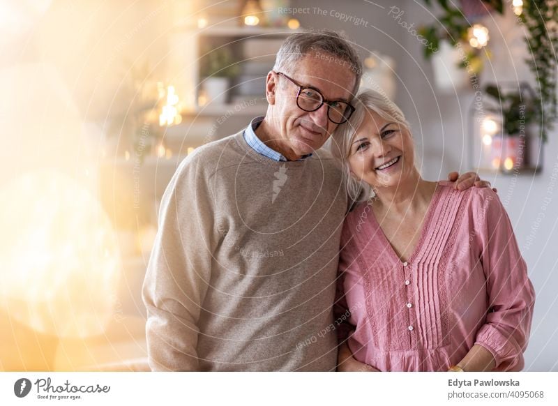 Happy senior couple at home people woman adult mature casual attractive female smiling happy Caucasian toothy enjoying two people love relationship portrait