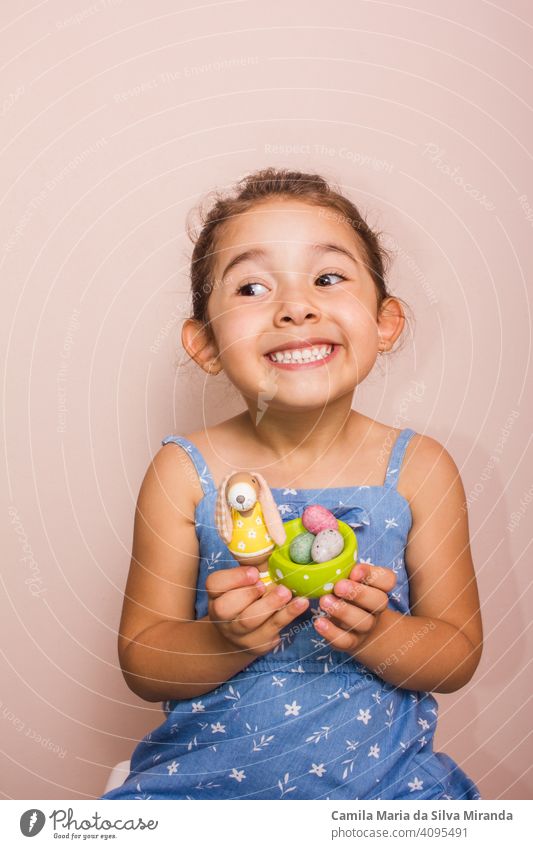 Happy child holding plate with mini chocolate eggs. april candy celebration childhood colorful copy space decoration dessert easter festive food fun happy