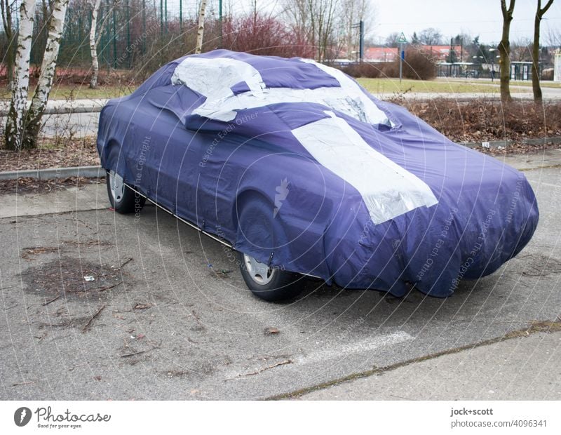 patched-up car tarpaulin for the family carriage Protection Structures and shapes Parking lot Outskirts Protective cover mark Concrete slab mend Parking area