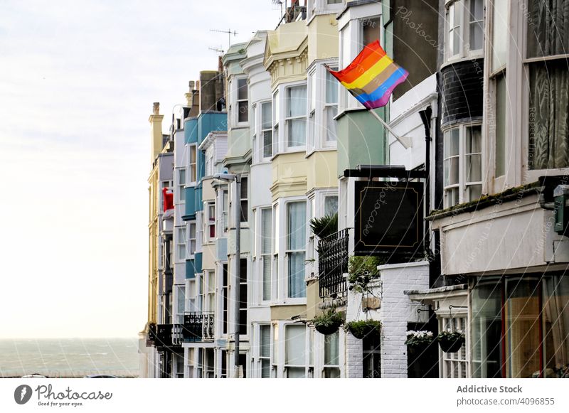 LGBT flag on town street lgbt residential building sea brighton england rainbow symbol exterior facade sky cloudy city pride sign colorful equality diversity