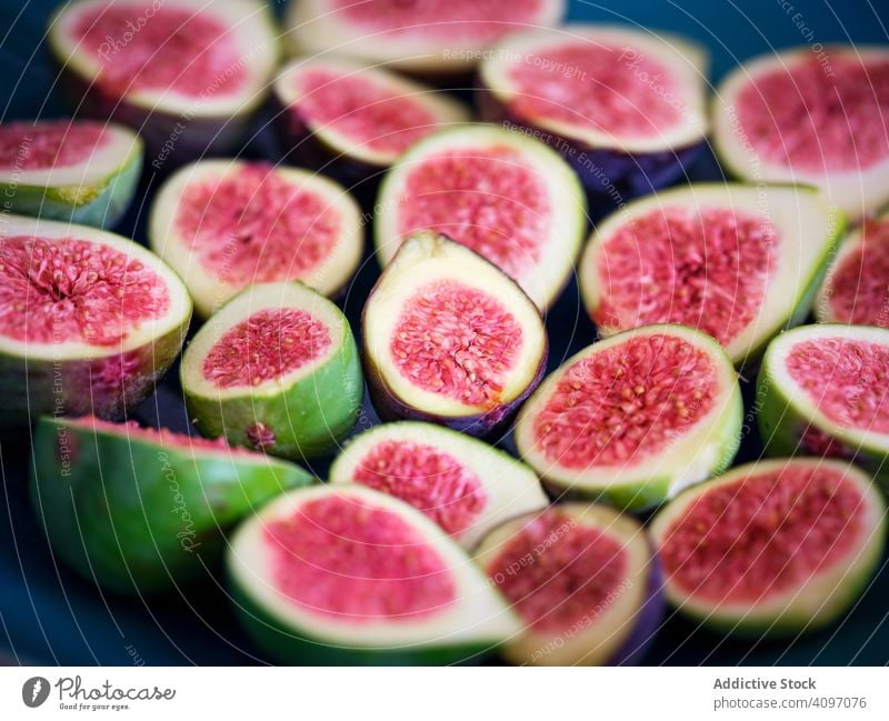 top view of half pieces of fig over blue plate mature rustic fresh fruits green rural tree food wooden traditional closeup spain home edible figs ripe bright