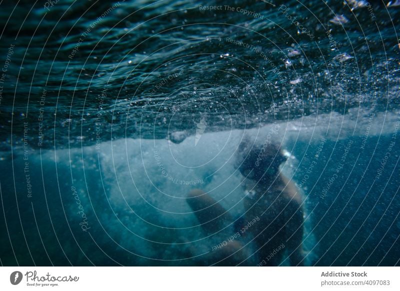 Male swimmer floating among sea waves boy underwater tranquil active surface training calm sport athlete person silent peace harmony energy guy leisure effort