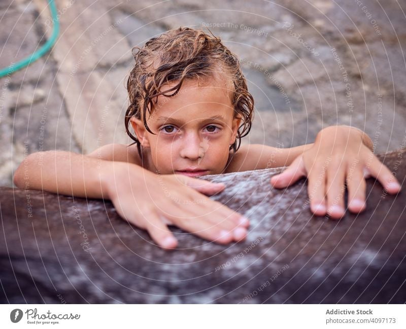 Delighted boy fondling stallion horse embrace love ranch harmony happy delighted kid hair care curly wet side child countryside horseback cheerful hobby