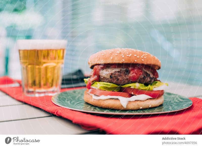 Cheeseburger with lettuce and tomato bun classic unhealthy table food meal cheeseburger onion beef delicious bbq grill snack hamburger american gourmet beer