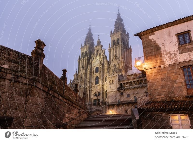 Santiago de Compostela Cathedral view at misty foggy night after rain. Cathedral of Saint James pilgrimage. Galicia, Spain ancient architecture baroque building