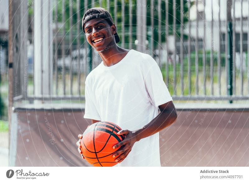 Black sportsmen with ball smiling and looking at camera player basketball activity athlete skill action black african american court athletic training