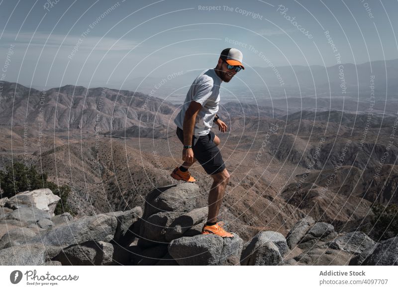 Tourist gazing while standing on edge of picturesque canyon tourist gaze cliff mountain range man contemplating summer usa hot backpack scenic greenery blue sky